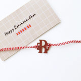 Rakhi - Initial